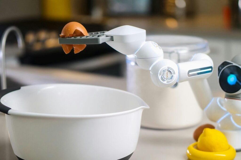 A robotic helper cracks an egg into a bowl in a contemporary kitchen setting, showcasing automation in cooking.
